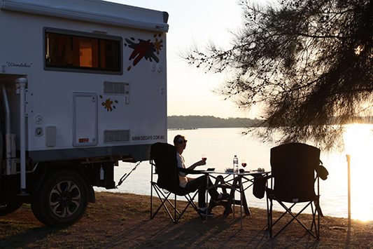Ozcape Slide-On motorhome Woondabaa happy hour at the lake